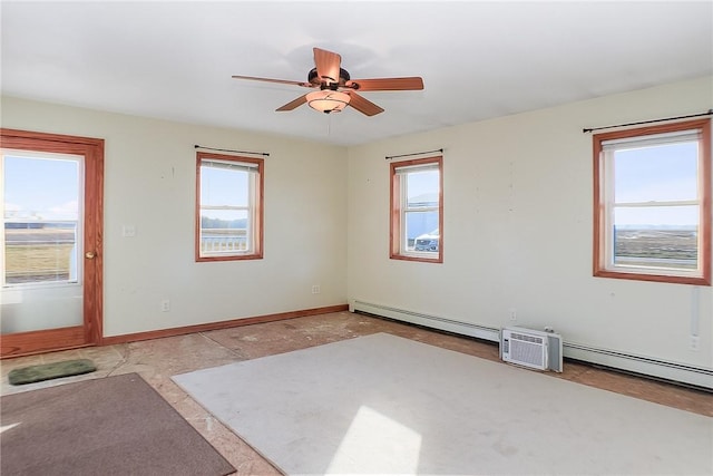 empty room featuring a baseboard heating unit and ceiling fan