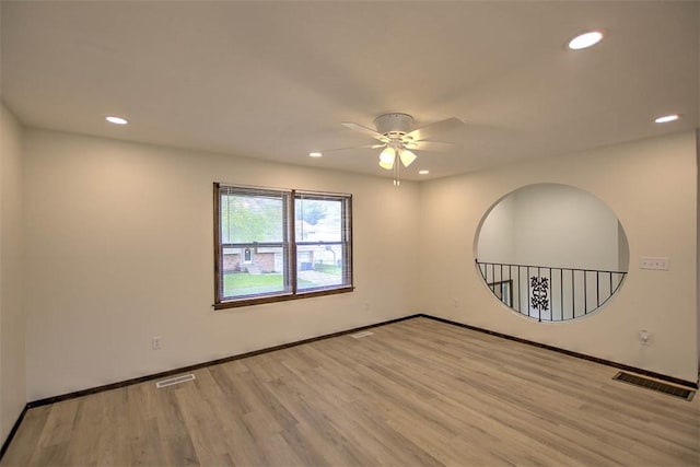 113 White Pines Cir, Decatur, IL 62521 - empty room with ceiling fan, wood finished floors, recessed lighting, and baseboards