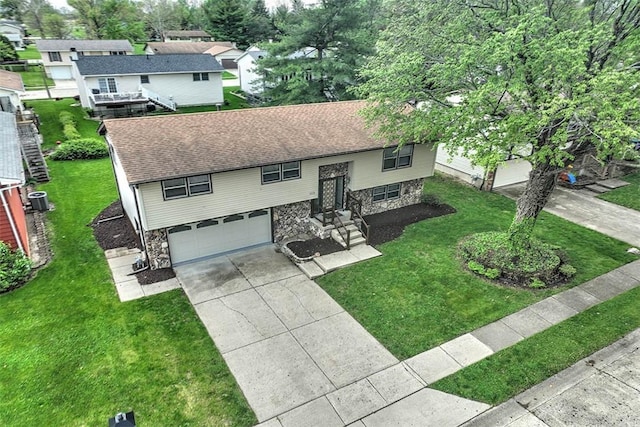 113 White Pines Cir, Decatur, IL 62521 - bi-level home featuring stone siding, a garage, concrete driveway, a front yard, and roof with shingles