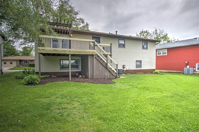 113 White Pines Cir, Decatur, IL 62521 - back of house with a wooden deck, stairs, and a lawn