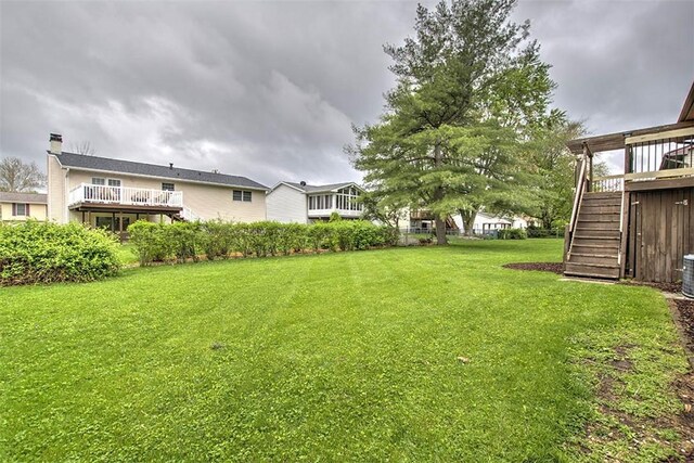 113 White Pines Cir, Decatur, IL 62521 - view of green lawn featuring stairway, a deck, and cooling unit
