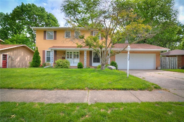 2290 N Kenwood Ct, Decatur, IL 62526 - traditional home featuring driveway, a garage, and a front yard