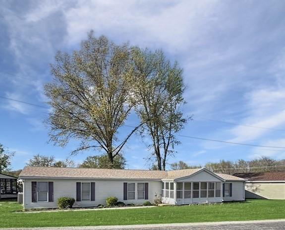ranch-style home with a front lawn