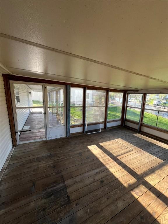 unfurnished sunroom with plenty of natural light