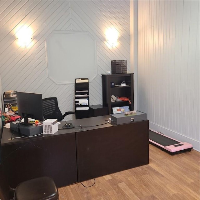office area featuring baseboards and light wood finished floors