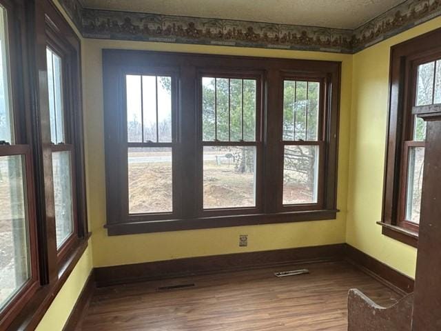 unfurnished sunroom with visible vents