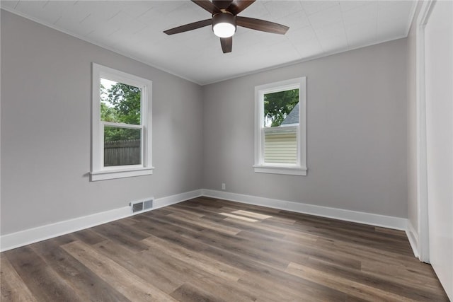 204 W Eiche Ave, Effingham, IL 62401 - spare room featuring plenty of natural light, crown molding, a ceiling fan, and dark wood-style flooring