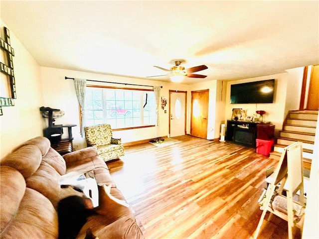 211 E 5th Ave, Rankin, IL 60960 - living area with wood finished floors, ceiling fan, stairs, and baseboards