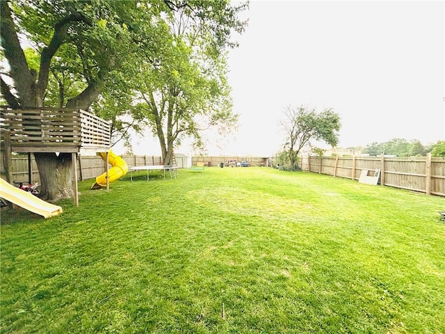 211 E 5th Ave, Rankin, IL 60960 - view of yard with a trampoline and a playground
