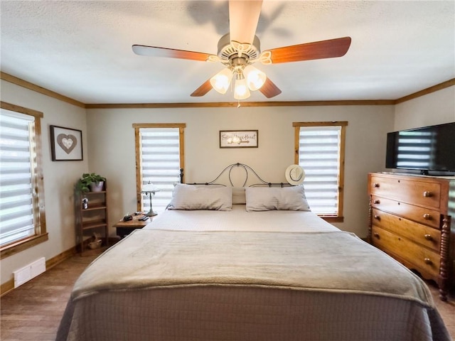 16781 E 1600th Ave, Palestine, IL 62451 - bedroom with baseboards, wood finished floors, ornamental molding, and a ceiling fan