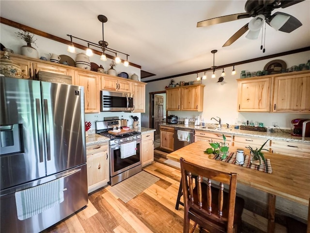 16781 E 1600th Ave, Palestine, IL 62451 - kitchen featuring stainless steel appliances, crown molding, a sink, light wood-style flooring, and pendant lighting