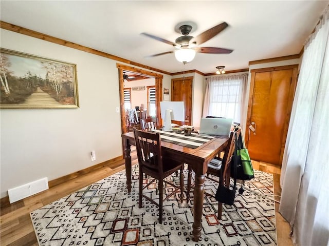 16781 E 1600th Ave, Palestine, IL 62451 - dining room featuring ceiling fan, baseboards, light wood finished floors, and ornamental molding