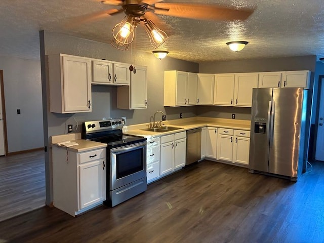 905 Oak St, Edgewood, IL 62426 - kitchen featuring stainless steel appliances, dark wood-style flooring, white cabinets, and a textured ceiling