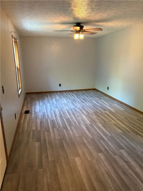 905 Oak St, Edgewood, IL 62426 - empty room featuring a textured ceiling, ceiling fan, and wood finished floors