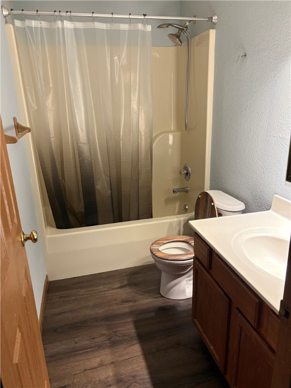 905 Oak St, Edgewood, IL 62426 - full bathroom featuring shower / bath combination with curtain, vanity, wood finished floors, and a textured wall