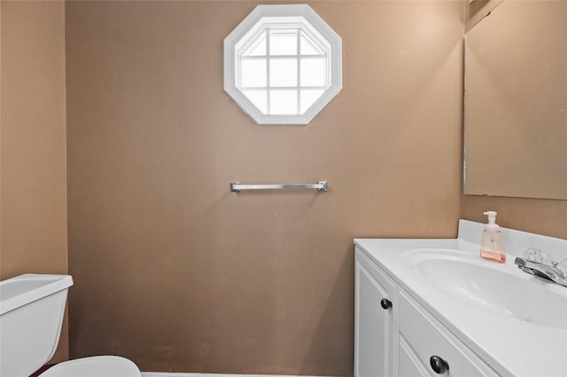 half bathroom featuring toilet and vanity