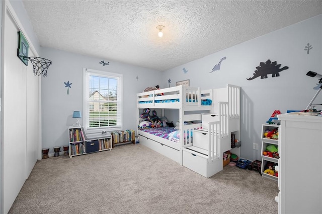bedroom with carpet and a textured ceiling