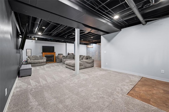 carpeted living room with baseboards and a fireplace
