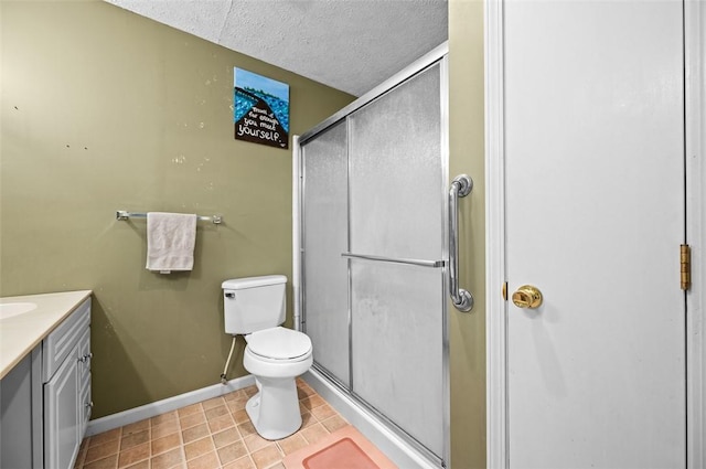full bath featuring baseboards, vanity, a textured ceiling, and a shower stall