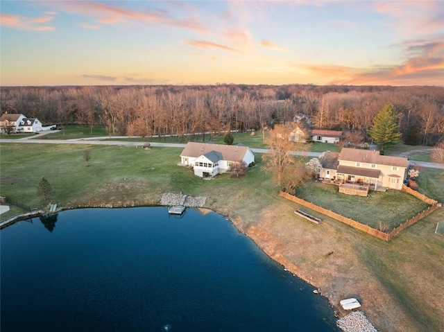 aerial view with a water view and a wooded view