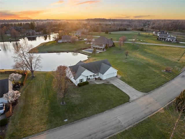 aerial view at dusk with a water view
