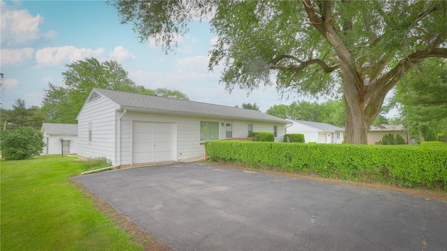 1302 Clement Ave, Forsyth, IL 62535 - single story home with an attached garage, asphalt driveway, and a front lawn