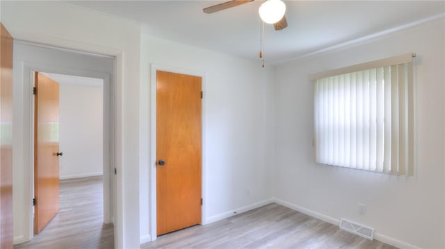 1302 Clement Ave, Forsyth, IL 62535 - unfurnished bedroom with light wood-style flooring, baseboards, and ceiling fan