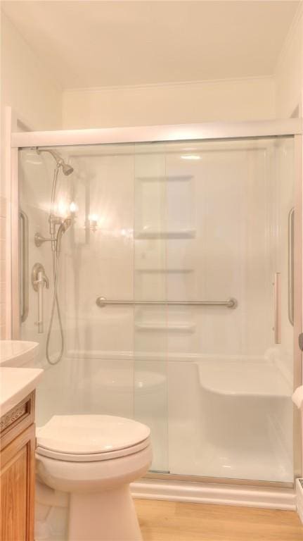 1302 Clement Ave, Forsyth, IL 62535 - full bath featuring vanity, toilet, a stall shower, and wood finished floors