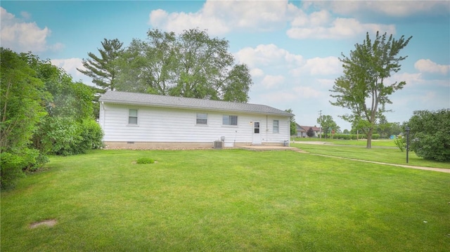 1302 Clement Ave, Forsyth, IL 62535 - rear view of house featuring central AC unit, a yard, and crawl space