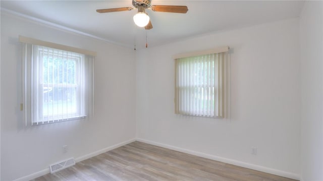 1302 Clement Ave, Forsyth, IL 62535 - unfurnished room with baseboards, wood finished floors, and ceiling fan