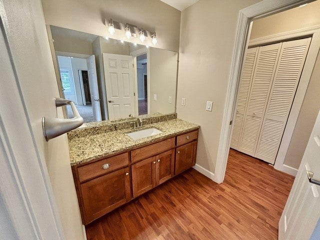 bathroom with hardwood / wood-style floors and vanity