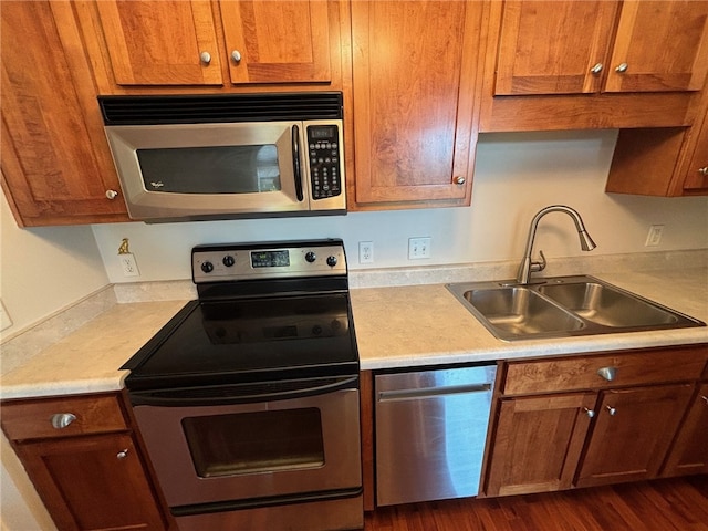 kitchen with dark hardwood / wood-style floors, sink, and stainless steel appliances