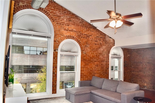 living room with a healthy amount of sunlight and brick wall