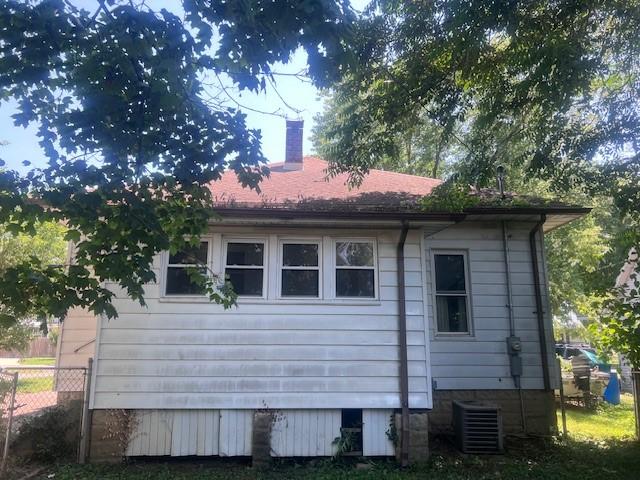 113 S 25th St, Mattoon, IL 61938 - view of side of home with a central air condition unit and a chimney