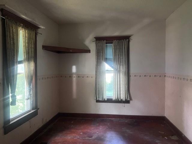 113 S 25th St, Mattoon, IL 61938 - spare room featuring wood finished floors and wainscoting