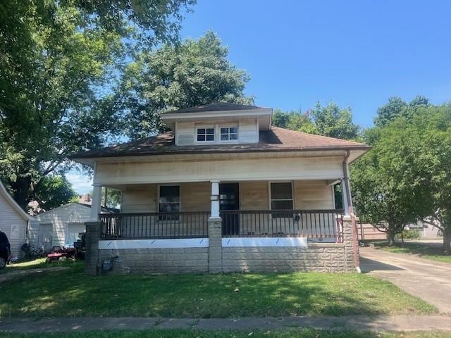 113 S 25th St, Mattoon, IL 61938 - bungalow-style house with a porch, a front lawn, and concrete driveway