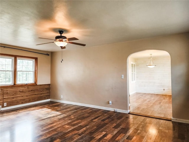 89 Pifers Ln, Sullivan, IL 61951 - unfurnished room featuring arched walkways, dark wood-style flooring, and a ceiling fan