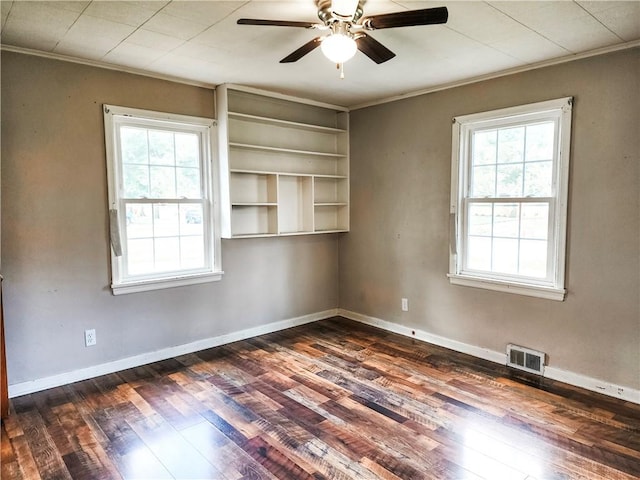 89 Pifers Ln, Sullivan, IL 61951 - unfurnished room with healthy amount of natural light, a ceiling fan, dark wood-type flooring, and ornamental molding