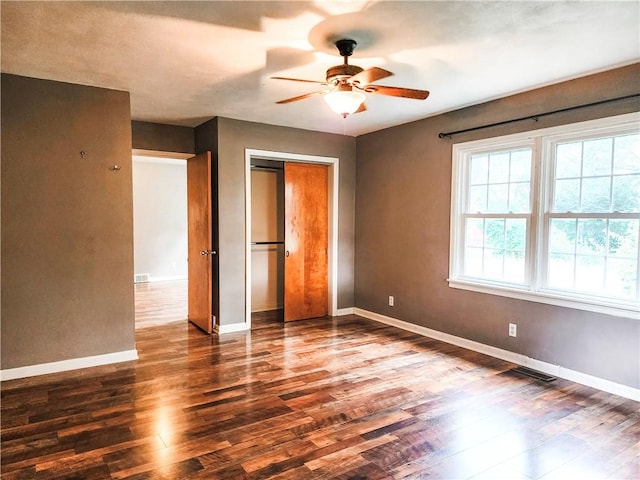 89 Pifers Ln, Sullivan, IL 61951 - unfurnished bedroom featuring dark wood-style flooring, a closet, and ceiling fan