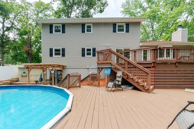 1230 Finley Ave, Mt Zion, IL 62549 - rear view of house featuring a deck, stairway, and an outdoor pool