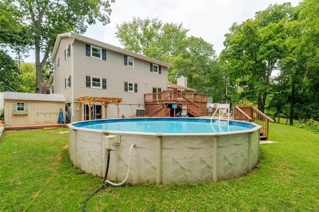1230 Finley Ave, Mt Zion, IL 62549 - outdoor pool featuring a deck, stairs, a lawn, view of wooded area, and an outdoor structure