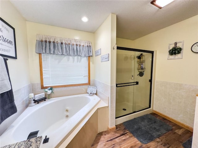 109 Brush Creek Dr, Marshall, IL 62441 - bathroom with a wainscoted wall, a textured ceiling, a stall shower, wood finished floors, and a jetted tub