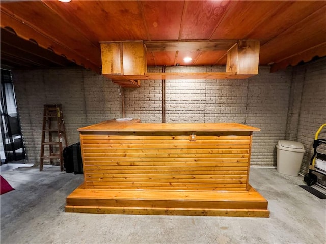 109 Brush Creek Dr, Marshall, IL 62441 - bar featuring wood ceiling, brick wall, a bar, and unfinished concrete floors