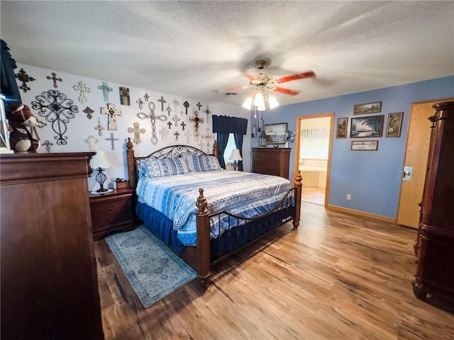 109 Brush Creek Dr, Marshall, IL 62441 - bedroom featuring wood finished floors, a textured ceiling, a ceiling fan, and baseboards