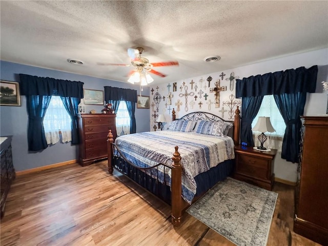 109 Brush Creek Dr, Marshall, IL 62441 - bedroom with baseboards, wood finished floors, a textured ceiling, and visible vents