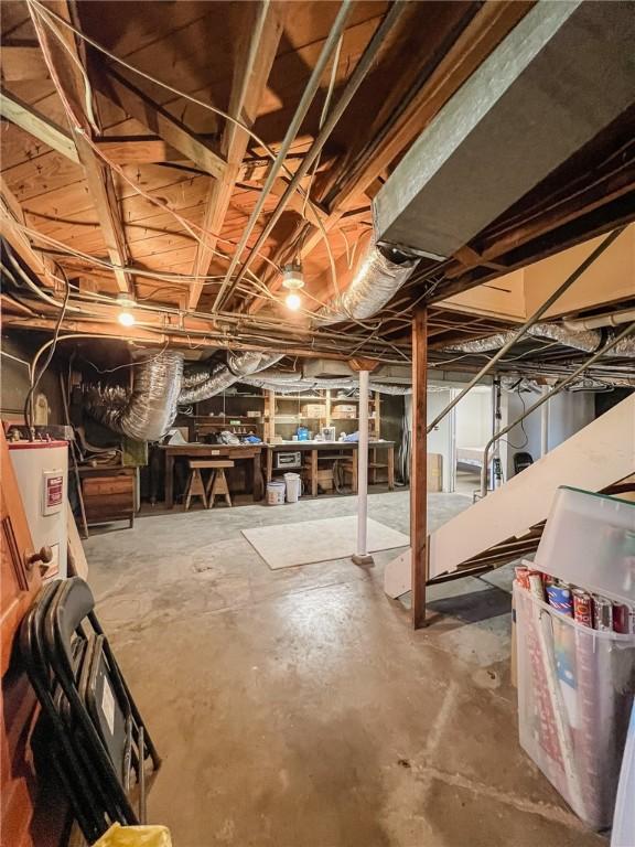 unfinished below grade area featuring electric water heater