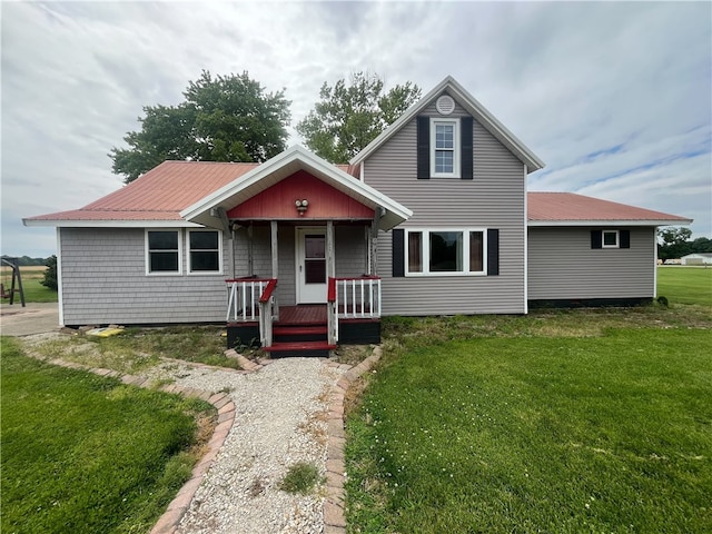 20301 E Darwin Ferry Rd, West Union, IL 62477 - traditional-style home featuring covered porch, a front yard, and metal roof