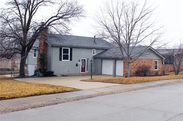 view of front of home featuring concrete driveway, an attached garage, and a chimney