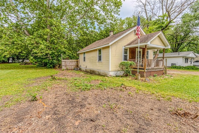 1750 N 31st St, Decatur, IL 62526 - view of property exterior featuring a porch, a chimney, and a shingled roof