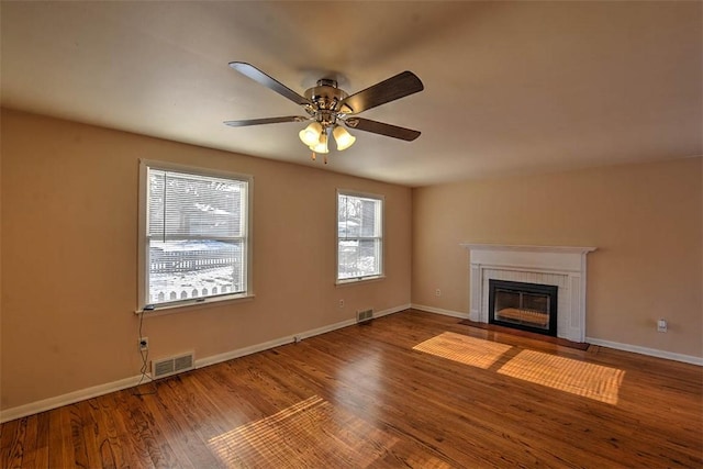 unfurnished living room featuring ceiling fan and hardwood / wood-style floors